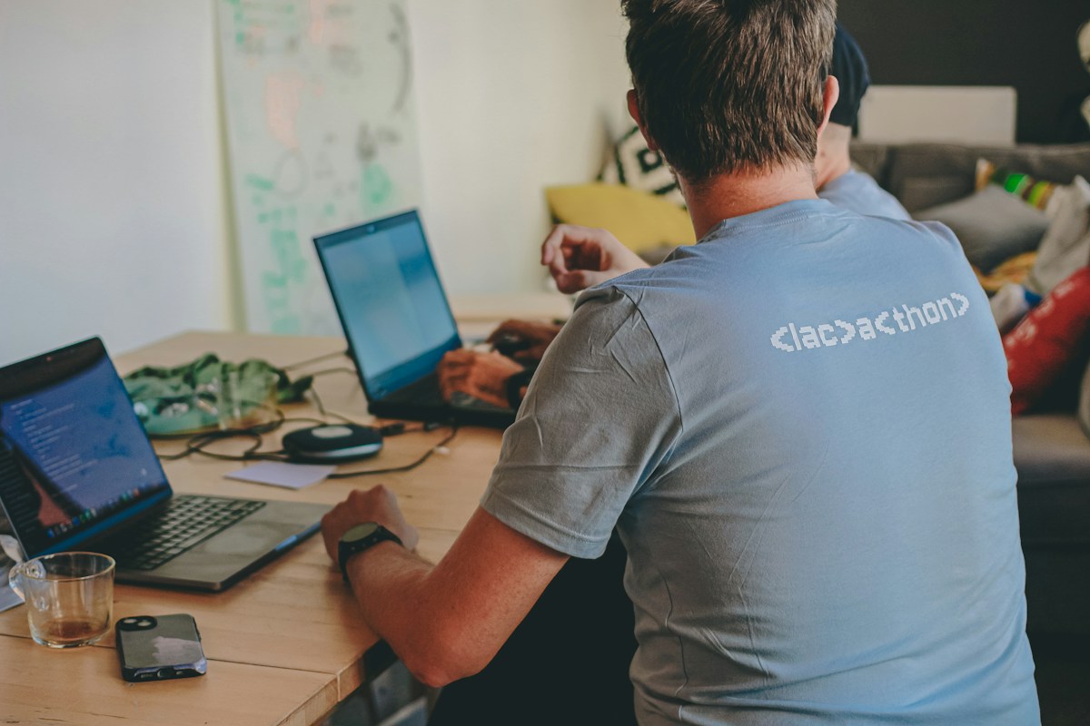 An engineer working on a laptop during a collaborative coding session